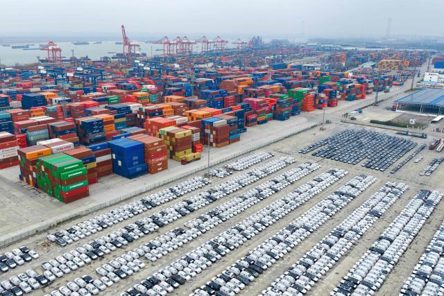 This aerial photo shows vehicles awaiting export at the port in Nanjing, in China’s eastern Jiangsu province on March 15, 2026. (Photo by CN-STR / AFP) / China OUT