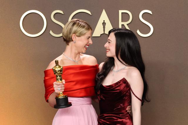 (L/R) Irish actress Jessie Buckley, winner of the Oscar for Best Actress in a Leading Role for "Hamnet," poses with US actress Mikey Madison in the press room during the 98th Annual Academy Awards at the Dolby Theatre in Hollywood, California on March 15, 2026. (Photo by VALERIE MACON / AFP)