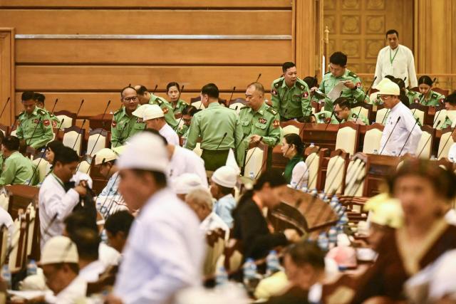 Members of Myanmar's parliament attend a session of the third term of the Pyithu Hluttaw (House of Representatives) in Naypyidaw on March 16, 2026. Myanmar parliament convened on March 16 for the first time since a 2021 military coup, AFP journalists saw, packed with pro-junta lawmakers elected in a poll choreographed by the top brass. (Photo by Sai Aung MAIN / AFP)
