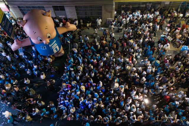 Supporters of Peru's presidential candidate Rafael Lopez Aliaga, for the Renovacion Popular party, are seen during a rally in the San Juan de Lurigancho district on the outskirts of Lima on March 15, 2026. Peru will hold presidential elections on April 12, 2026. (Photo by Ernesto BENAVIDES / AFP)