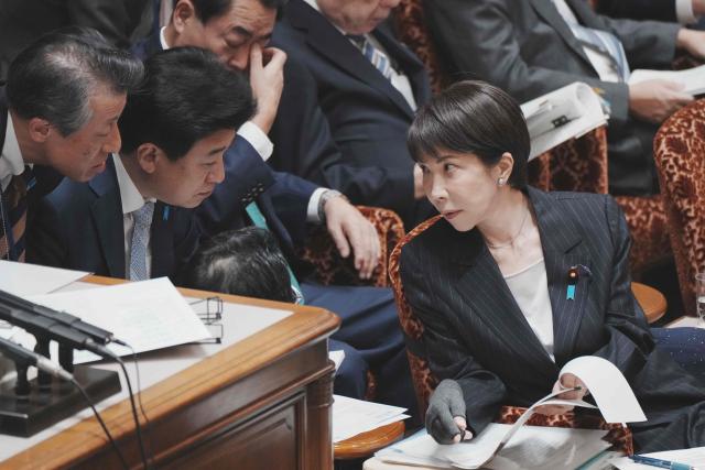 Japan's Prime Minister Sanae Takaichi (R) chats with Chief Cabinet Secretary Minoru Kihara (2nd L) and others during a budget committee session of the House of Councillors in Parliament in Tokyo on March 16, 2026. (Photo by Kazuhiro NOGI / AFP)