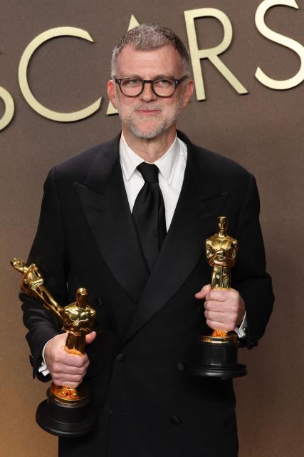 US director Paul Thomas Anderson poses in the press room with the Oscars for best Best Picture, Best Director and Best Writing (Adapted Screenplay) for "Sinners" during the 98th Annual Academy Awards at the Dolby Theatre in Hollywood, California on March 15, 2026. (Photo by VALERIE MACON / AFP)