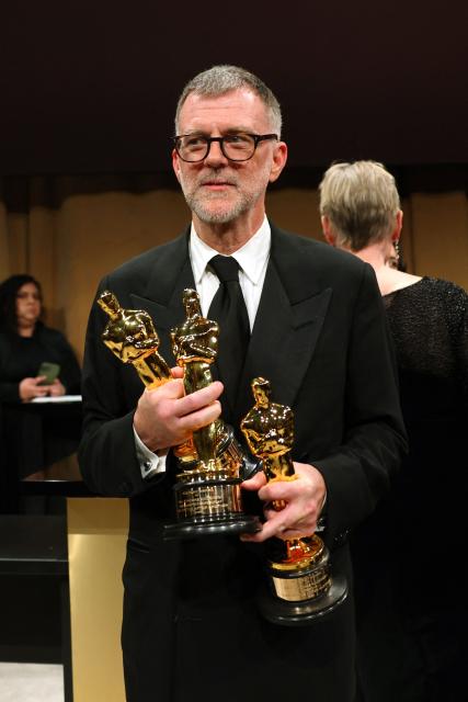 US director Paul Thomas Anderson stands with his Oscars for Best Picture, Best Adapted Screenplay and Best Director for "One Battle After Another"  during the 98th Annual Academy Awards Governors Ball at the Dolby Theatre in Hollywood, California on March 15, 2026. (Photo by ANGELA WEISS / AFP)
