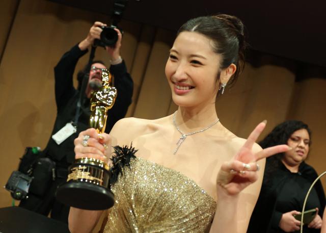 South Korean-US singer Ejae poses with the Oscar for Best Music (Original Song) for "Golden" from "KPop Demon Hunters" during the 98th Annual Academy Awards Governors Ball at the Dolby Theatre in Hollywood, California on March 15, 2026. (Photo by ANGELA WEISS / AFP)