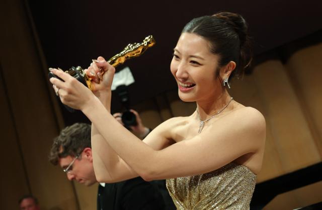 South Korean-US singer Ejae poses with the Oscar for Best Music (Original Song) for "Golden" from "KPop Demon Hunters" during the 98th Annual Academy Awards Governors Ball at the Dolby Theatre in Hollywood, California on March 15, 2026. (Photo by ANGELA WEISS / AFP)
