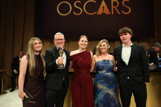 US visual effects supervisor Daniel Barrett (2L) holds his Oscar for Best Visual Effects for "Avatar: Fire and Ash" poses with family during the 98th Annual Academy Awards Governors Ball at the Dolby Theatre in Hollywood, California on March 15, 2026. (Photo by ANGELA WEISS / AFP)