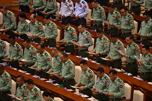 Military officers who serve as members of Myanmar's parliament attend a session of the third term of the Pyithu Hluttaw (House of Representatives) in Naypyidaw on March 16, 2026. Myanmar parliament convened on March 16 for the first time since a 2021 military coup, AFP journalists saw, packed with pro-junta lawmakers elected in a poll choreographed by the top brass. (Photo by Sai Aung MAIN / AFP)