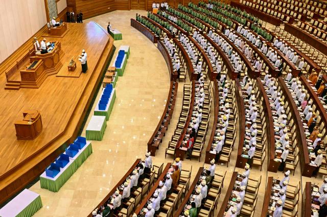 Members of Myanmar's parliament attend a session of the third term of the Pyithu Hluttaw (House of Representatives) in Naypyidaw on March 16, 2026. Myanmar parliament convened on March 16 for the first time since a 2021 military coup, AFP journalists saw, packed with pro-junta lawmakers elected in a poll choreographed by the top brass. (Photo by Sai Aung MAIN / AFP)