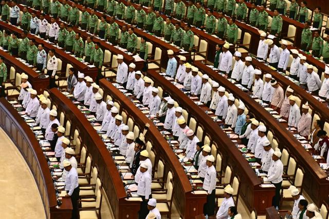 Members of Myanmar's parliament attend a session of the third term of the Pyithu Hluttaw (House of Representatives) in Naypyidaw on March 16, 2026. Myanmar parliament convened on March 16 for the first time since a 2021 military coup, AFP journalists saw, packed with pro-junta lawmakers elected in a poll choreographed by the top brass. (Photo by Sai Aung MAIN / AFP)