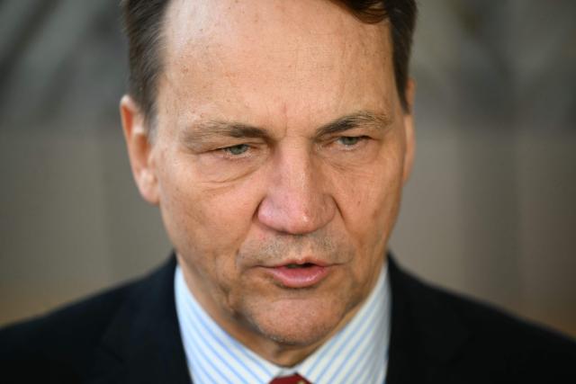 Poland's Foreign Minister Rados?aw Sikorski speaks to the media as he arrives for a Foreign Affairs Council to discuss Russia’s war of aggression against Ukraine and the situation in the Middle East, in Brussels on March 16, 2026. (Photo by NICOLAS TUCAT / AFP)