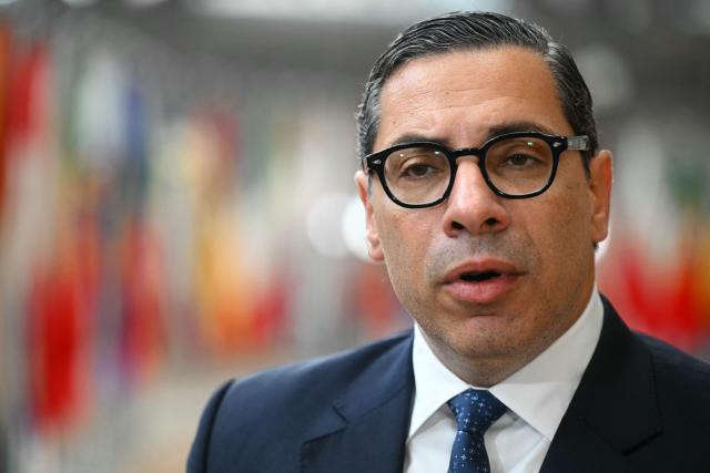Cyprus' Foreign Minister Constantinos Kombos speaks to the media as he arrives for a Foreign Affairs Council to discuss Russia’s war of aggression against Ukraine and the situation in the Middle East, in Brussels on March 16, 2026. (Photo by NICOLAS TUCAT / AFP)