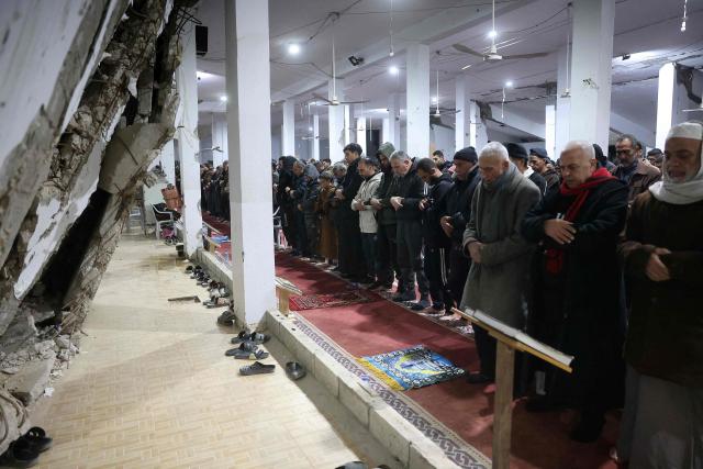 Muslims pray on Laylat al-Qadr (Night of Destiny) during the holy fasting month of Ramadan at the Mahaba Mosque which was previously damaged during the Israel-Hamas war in Khan Yunis in the southern Gaza Strip on March 16, 2026. Israel said it would partially reopen Gaza's Rafah crossing with Egypt this week, after it closed the key gateway when it launched a joint attack on Iran with the US. (Photo by Bashar Taleb / AFP)