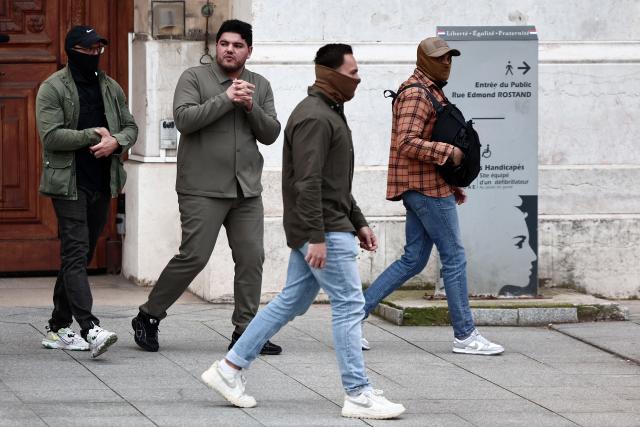 Escorted French anti-drug activist and electoral candidate Amine Kessaci (2nd-L) leaves after Marseille's incumbent mayor and broad left-wing coalition "Printemps Marseillais" candidate for re-election Benoit Payan (unseen) submitted a list, the day following the first round of France's 2026 municipal elections at the prefecture in Marseille, southern France, on March 16, 2026. Benoоt Payan, wants no backroom deals and is going it alone in the second round, calling on “everyone to take responsibility” in the face of the National Rally, which is “at Marseille’s doorstep,” putting both LFI and the right under pressure. (Photo by Thibaud MORITZ / AFP)