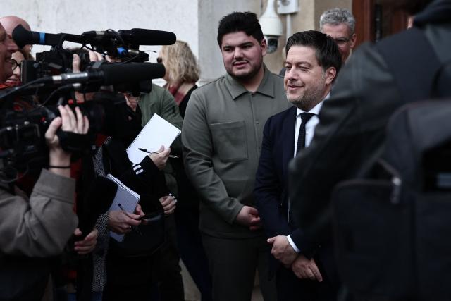 Marseille's incumbent mayor and broad left-wing coalition "Printemps Marseillais" candidate for re-election Benoit Payan (R), accompanied by French anti-drug activist and electoral candidate Amine Kessaci (C), addresses media as he leaves the prefecture after submitting a list, the day following the first round of France's 2026 municipal elections in Marseille, southern France, on March 16, 2026. Benoоt Payan, wants no backroom deals and is going it alone in the second round, calling on “everyone to take responsibility” in the face of the National Rally, which is “at Marseille’s doorstep,” putting both LFI and the right under pressure. (Photo by Thibaud MORITZ / AFP)