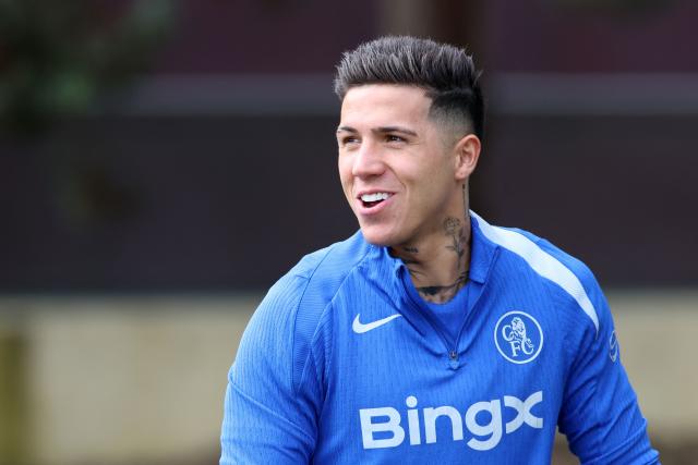 Chelsea's Argentinian midfielder #08 Enzo Fernandez smiles as he arrives to take part in a team training session at the Chelsea training ground in Cobham, west of London on March 16, 2026, on the eve of their UEFA Champions League, Last 16 second leg football match against Paris Saint-Germain (PSG). (Photo by Toby Shepheard / AFP)