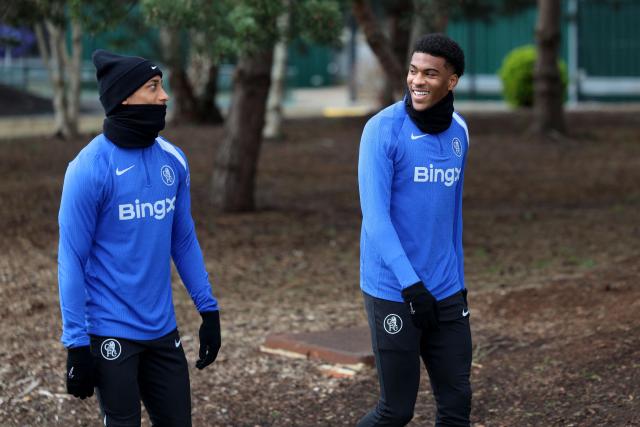 Chelsea's English defender #34 Josh-Kofi Acheampong (R) and Chelsea's Brazilian striker #20 Joao Pedro arrive to take part in a team training session at the Chelsea training ground in Cobham, west of London on March 16, 2026, on the eve of their UEFA Champions League, Last 16 second leg football match against Paris Saint-Germain (PSG). (Photo by Toby Shepheard / AFP)