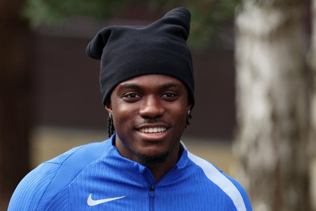 Chelsea's Belgian midfielder #45 Romeo Lavia smiles as he arrives to take part in a team training session at the Chelsea training ground in Cobham, west of London on March 16, 2026, on the eve of their UEFA Champions League, Last 16 second leg football match against Paris Saint-Germain (PSG). (Photo by Toby Shepheard / AFP)