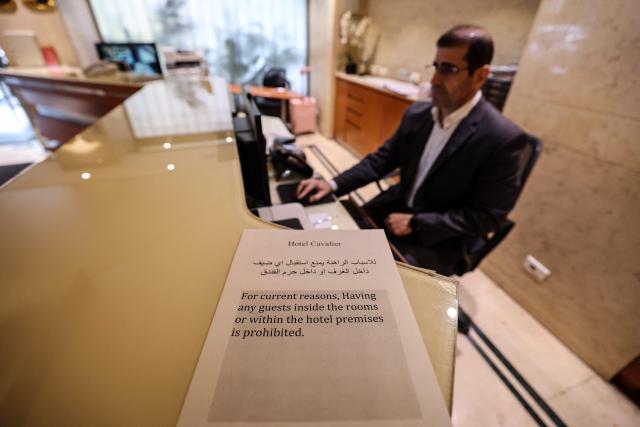 A printed notice is placed at the reception desk of a hotel, informing clients that guests are forbidden from visiting the hotel due to the war situation in Beirut on March 16, 2026. On February 28, Israel and the United States launched strikes on Iran, killing its supreme leader and triggering a war that spread across the Middle East, with Lebanon's Hezbollah entering the fray. Lebanon's health ministry said on March 14, that Israeli strikes have killed 850 people, including 66 women and 107 children, since the start of the war with Hezbollah, adding that 2,105 others were wounded. (Photo by Anwar AMRO / AFP)