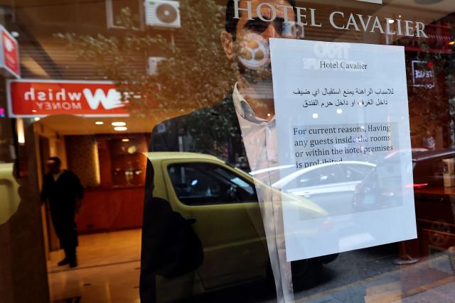 A printed notice taped near in the window of a hotel informs clients that guests are forbidden from visiting the hotel due to the war situation in Beirut on March 16, 2026. On February 28, Israel and the United States launched strikes on Iran, killing its supreme leader and triggering a war that spread across the Middle East, with Lebanon's Hezbollah entering the fray. Lebanon's health ministry said on March 14, that Israeli strikes have killed 850 people, including 66 women and 107 children, since the start of the war with Hezbollah, adding that 2,105 others were wounded. (Photo by Anwar AMRO / AFP)