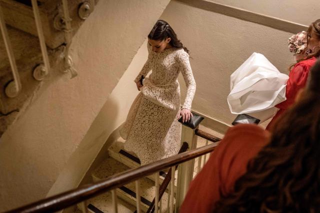 TOPSHOT - Wedding guests make their way into a bomb shelter after sirens wailed of an impending projectile attack in Jerusalem on March 16, 2026. On February 28, Israel and the United States launched strikes on Iran, killing its supreme leader Ayatollah and triggering a war that spread across the Middle East. (Photo by JOHN WESSELS / AFP)