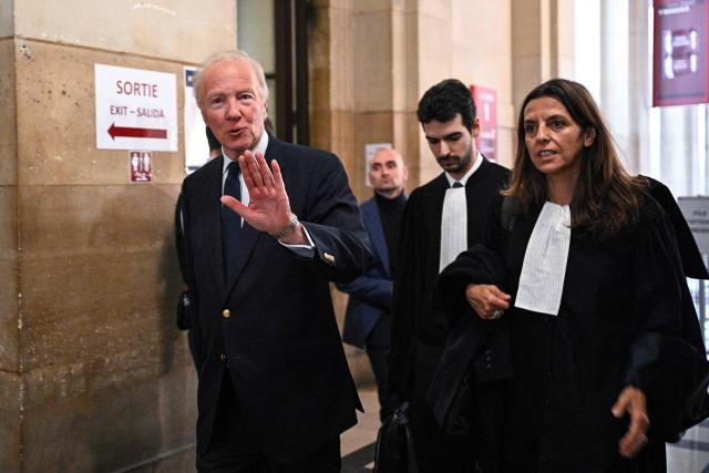 Defendant Brice Hortefeux (L), former Interior minister, arrives for the appeal trial of France's former president Nicolas Sarkozy over charges he sought Libyan financing for his 2007 election, at the Paris Appeal Court in the Palais de Justice courthouse in Paris on March 16, 2026. The Paris Criminal Court in September 2025 convicted Sarkozy of criminal conspiracy and handed him a 5-year prison sentence over what it said was a scheme to acquire funding from Muammar Gaddafi's Libya for his 2007 presidential run that saw him elected. The right-wing politician -- who has denied any wrongdoing -- entered a Paris jail in October 2025, serving 20 days before he was released under judicial supervision. (Photo by JULIEN DE ROSA / AFP)