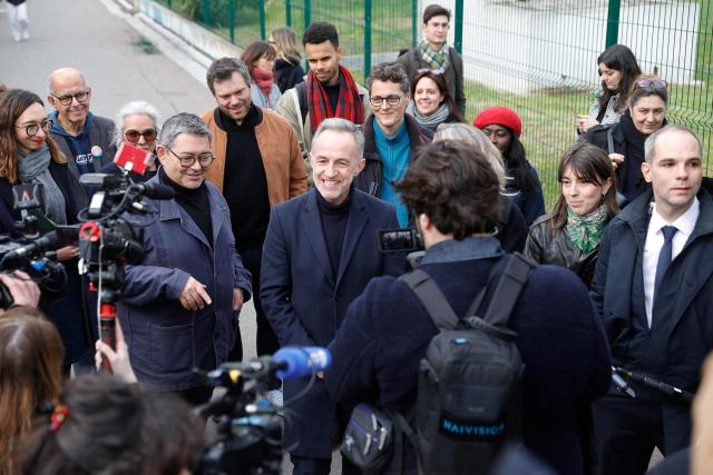 Socialist party (PS) mayoral candidate for Paris Emmanuel Gregoire (C) and reelected PS Mayor of Paris' 13th arrondissement Jerome Coumet (L) stroll through the Olympiades neighbourhood as part of his electoral campaign in Paris on March 16, 2026, a day after the first round of municipal elections in France. In Paris, Socialist candidate Emmanuel Gregoire is in the lead ahead of former culture minister Rachida Dati. Gregoire has promised to carry on the legacy of outgoing Socialist mayor Anne Hidalgo, including increasing the number of bike lanes and green spaces and improving public housing in the densely populated city of two million people. (Photo by GEOFFROY VAN DER HASSELT / AFP)