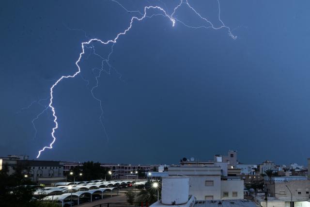 Lightning strikes the sky in Kuwait City during a thunder storm on March 16, 2026. (Photo by YASSER AL-ZAYYAT / AFP)