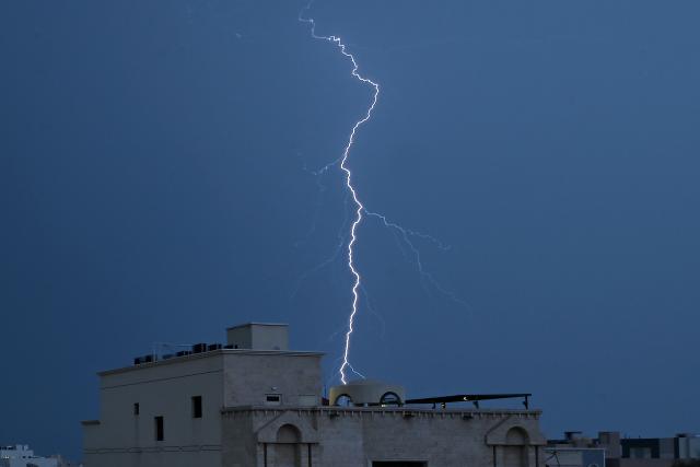 Lightning strikes the sky in Kuwait City during a thunder storm on March 16, 2026. (Photo by YASSER AL-ZAYYAT / AFP)