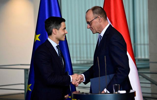 German Chancellor Friedrich Merz (R) and Netherlands' Prime Minister Rob Jetten shake hands at the end of a press conference at the chancellery in Berlin, on March 16, 2026 (Photo by Tobias SCHWARZ / AFP)