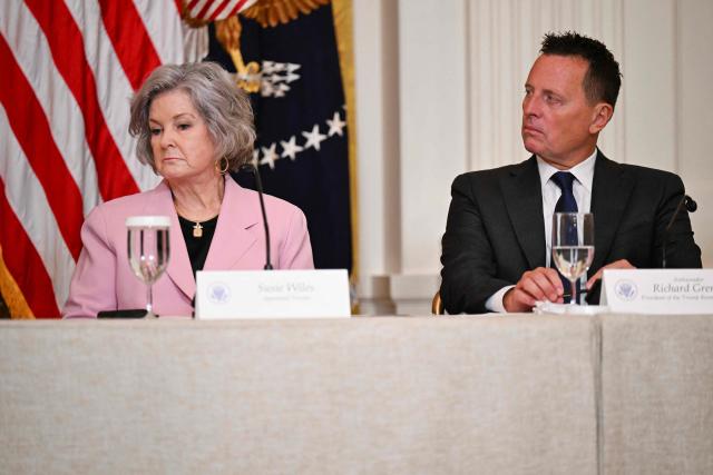 (L/R) White House Chief of Staff Susie Wiles and Richard Grenell, outgoing President of The Kennedy Center Board of Trustees, look on as US President Donald Trump speaks during a lunch with the Kennedy Center Board Members in the East Room of the White House on March 16, 2026 in Washington, DC. (Photo by Annabelle GORDON / AFP)