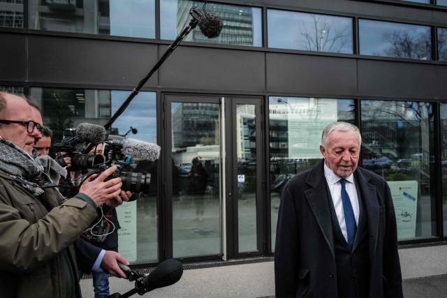 Lyon's mayoral candidate, whose list is supported by right-wing Les Republicains (LR) party and centrist party Renaissance, Jean-Michel Aulas arrives to speak to inhabitants surrounded by journalists as part of his campaign for the second round of France's 2026 local elections in Lyon, central-eastern France, on March 16, 2026. Long considered the frontrunner in the polls for the Lyon mayoral election, the former Olympique Lyonnais President said he was "disappointed" on March 15, 2026 to find himself neck and neck with Green Party mayor in the first round, ahead of the La France Insoumise (LFI) candidate in third. (Photo by OLIVIER CHASSIGNOLE / AFP)