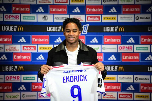 (FILES) Olympique Lyonnais’ Brazilian forward #09 Endrick poses with his jersey as he takes part in his official presentation press conference at the OL training centre in Decines-Charpieu, in the suburbs of Lyon, central-eastern France, on January 5, 2026. Young striker Endrick, who has enjoyed a resurgence since joining Olympique Lyon on loan from Real Madrid, is the standout new addition to Brazil’s squad for this month’s friendlies against France and Croatia, head coach Carlo Ancelotti announced on March 16, 2026. (Photo by OLIVIER CHASSIGNOLE / AFP)
