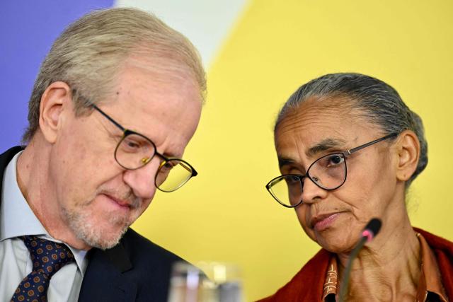 Brazil's Environment Minister Marina Silva speaks with her executive secretary, Joao Paulo Capobianco during the presentation of the National Climate Change Plan during a press conference at Planalto Palace in Brasilia on March 16, 2026. (Photo by Evaristo Sa / AFP)