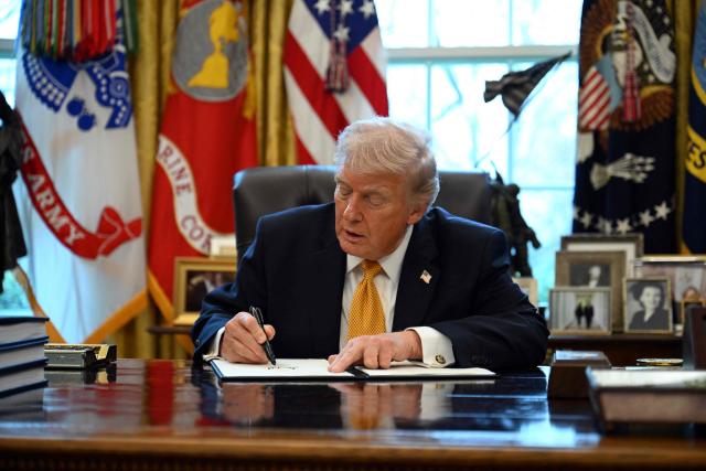 US President Donald Trump signs an executive order on fraud in the Oval Office at the White House in Washington, DC, on March 16, 2026. (Photo by ANNABELLE GORDON / AFP)
