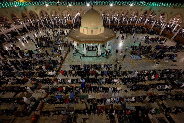 Muslims chant the Tarawih recitations on the occasion of Laylat al-Qadr which falls on the 27th day of the fasting month of Ramadan, at Cairo's Amr Ibn al-Aas mosque late on March 16, 2026. Laylat al-Qadr, or Night of Destiny, marks the night Muslims believe the first verses of the Koran were revealed to the Prophet Mohammed through the archangel Gabriel. (Photo by Khaled DESOUKI / AFP)