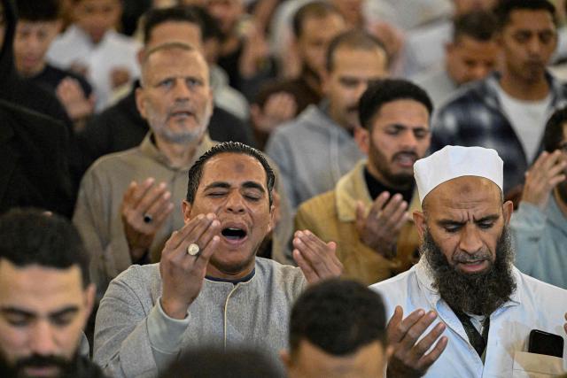 Muslims chant the Tarawih recitations on the occasion of Laylat al-Qadr which falls on the 27th day of the fasting month of Ramadan, at Cairo's Amr Ibn al-Aas mosque late on March 16, 2026. Laylat al-Qadr, or Night of Destiny, marks the night Muslims believe the first verses of the Koran were revealed to the Prophet Mohammed through the archangel Gabriel. (Photo by Khaled DESOUKI / AFP)