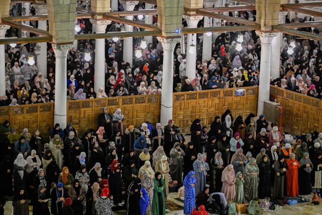 Muslims chant the Tarawih recitations on the occasion of Laylat al-Qadr which falls on the 27th day of the fasting month of Ramadan, at Cairo's Amr Ibn al-Aas mosque late on March 16, 2026. Laylat al-Qadr, or Night of Destiny, marks the night Muslims believe the first verses of the Koran were revealed to the Prophet Mohammed through the archangel Gabriel. (Photo by Khaled DESOUKI / AFP)