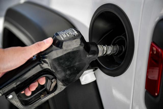 A man uses a gas pump at a Shell gas station in Houston, Texas, on March 16, 2026. Oil prices retreated and equities rose Monday as investors remained focused on the Strait of Hormuz, with US allies pushing back against President Donald Trump's demands to help reopen the key waterway to oil and natural gas tankers. (Photo by RONALDO SCHEMIDT / AFP)
