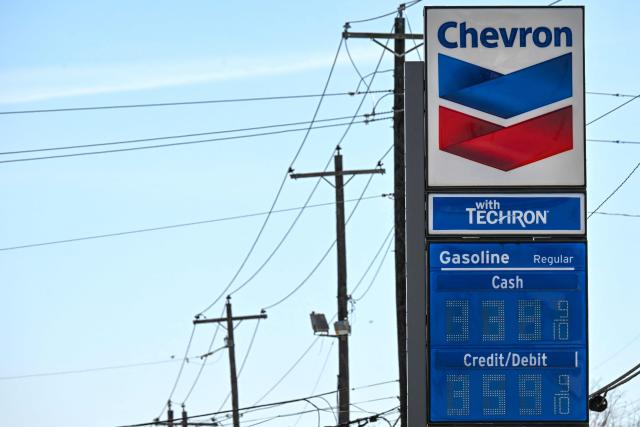 Gasoline prices are seen at a Chevron gas station in Houston, Texas, on March 16, 2026. Oil prices retreated and equities rose Monday as investors remained focused on the Strait of Hormuz, with US allies pushing back against President Donald Trump's demands to help reopen the key waterway to oil and natural gas tankers. (Photo by RONALDO SCHEMIDT / AFP)