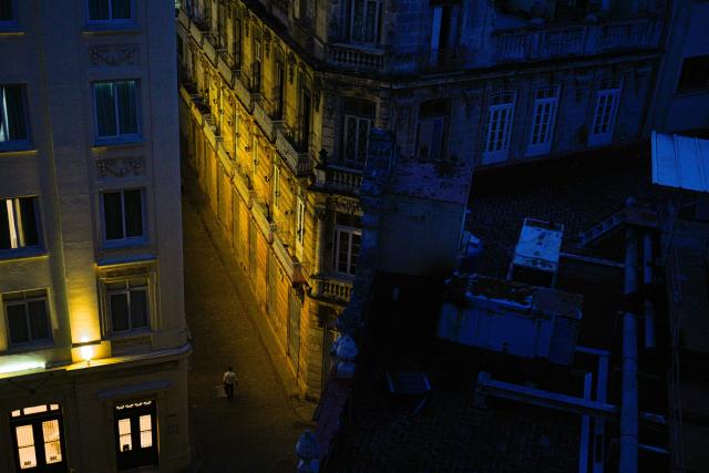 TOPSHOT - A hotel remains lit by its own system during a blackout in Havana on March 16, 2026. Cuba suffered a widespread power cut on March 16, 2026, according to the national electricity company, against the backdrop of a severe crisis on the island caused by the US energy blockade. (Photo by ADALBERTO ROQUE / AFP)