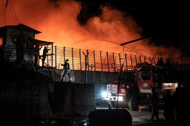 Afghan firefighters and Taliban security personnel work to extinguish a fire at the Secondary Rehabilitation Services Centre in Kabul on March 16, 2026. Heavy casualties were feared on March 17 after Afghanistan accused Pakistan of hitting a treatment centre for drug addicts in the capital, Kabul, and killing civilians. Pakistan denied deliberately targeting the facility, instead saying it had conducted precision strikes on "military installations and terrorist support infrastructure". The Pakistani military has struck Kabul several times in recent weeks, as part of a conflict sparked by claims that the Taliban government has harboured extremists who have carried out attacks across the border. (Photo by Wakil KOHSAR / AFP)