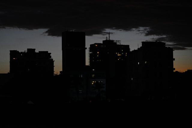This view shows buildings during a blackout in Havana on March 16, 2026. Cuba suffered a widespread power cut on March 16, 2026, according to the national electricity company, against the backdrop of a severe crisis on the island caused by the US energy blockade. (Photo by Yamil LAGE / AFP)