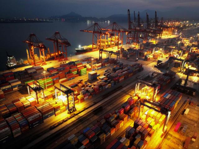 Cargo containers are seen at the terminal in Lianyungang, eastern China's Jiangsu province on March 17, 2026. (Photo by CN-STR / AFP) / China OUT