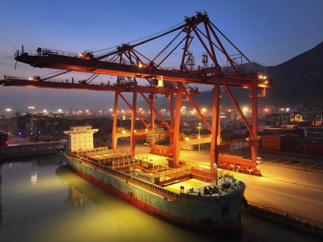 A cargo ship is docked at the container terminal in Lianyungang, eastern China's Jiangsu province on March 17, 2026. (Photo by CN-STR / AFP) / China OUT