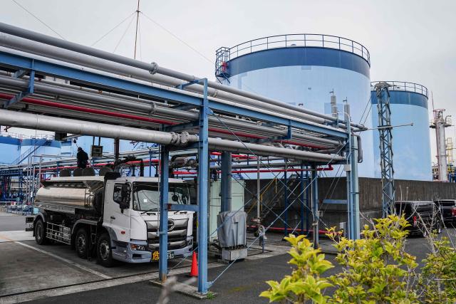 A tank lorry refuels at an oil terminal in Yokohama, Kanagawa prefecture on March 17, 2026. Oil prices resumed their push higher on March 17 as several countries pushed back against Donald Trump's demand that they help secure the key Strait of Hormuz, while Iran continued to target crude-producing neighbours. (Photo by Yuichi YAMAZAKI / AFP)