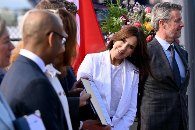 Denmark’s King Frederik X (R) and Queen Mary (C) react as they meet representatives from renewable energy companies with the Danish business delegation at the Port of Melbourne on March 17, 2026, as part of their five-day state visit to Australia. (Photo by William WEST / POOL / AFP)
