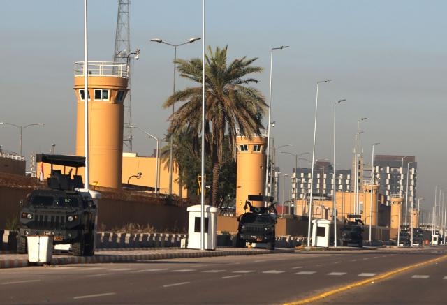Security is stationed outside the US Embassy is seen in Baghdad's fortified "Green Zone" on  March 17, 2026. A security official said a drone and rocket attack targeted the US embassy in Baghdad early March 17, following a similar attack hours earlier. An AFP correspondent reported seeing black smoke rising after an explosion at the embassy compound. Iraq, long a proxy battleground between the United States and Iran, was quickly dragged into the Middle East war triggered by US and Israeli strikes on Iran on February 28. (Photo by AHMAD AL-RUBAYE / AFP) / 