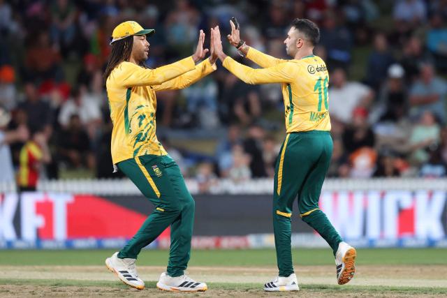 South Africa's Keshav Maharaj (R) and Tony de Zorzi celebrate the wicket of New Zealand’s  Tom Latham during the second Twenty20 international cricket match between New Zealand and South Africa played at Seddon Park in Hamilton on March 17, 2026. (Photo by Michael Bradley / AFP)