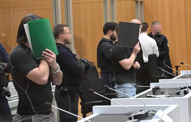 Three Ukrainian defendants, who are accused for plotting to send exploding parcels from Germany to Ukraine on the orders of a Russian intelligence service, wait for the start of their trial in the courtroom of the higher regional court in Stuttgart-Stammheim, southern Germany on March 17, 2026. Three Ukrainians go on trial in Germany, for allegedly  plotting sabotage attacks in Germany and Ukraine as part of what Berlin calls a campaign of Russian "hybrid" operations.
The suspects are accused of trying to send parcels that would "ignite in Germany or elsewhere on their way to parts of Ukraine not occupied by Russia". (Photo by THOMAS KIENZLE / AFP) / / EDITORS NOTE:  According to court's ruling the face of the judiciary officers and defendants should be made unrecognizable