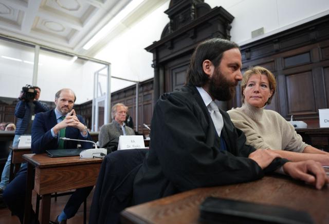 Defendant German entrepreneur and gastronome Christina Block (R) and co-defendant German former sports journalist Gerhard Delling (2L) wait for the continuation of the trial over alleged child abduction at the District Court in Hamburg, northern Germany, on March 17, 2026. The public prosecutor's office accuses Block, heiress of a steakhouse chain, of ordering the abduction of her daughter, born in 2010, and her son, born in 2013. According to the indictment, the background to this is an escalating custody dispute over many years between Block and her former husband, who have four children together. (Photo by Marcus Brandt / POOL / AFP)